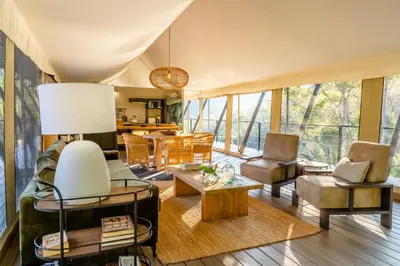 a living room with a lot of windows at Mbizane Escarpment Retreat in Schoemanskloof
