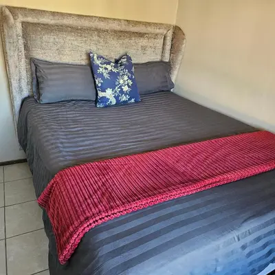 a bed with two pillows on top of it at The Retreat, Midrand - 2bed 2bath in Midrand