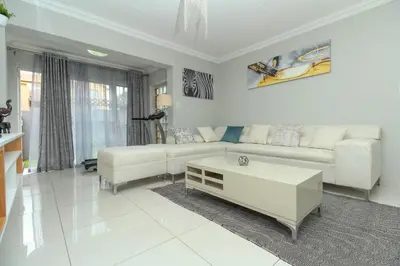 a living room with a couch and a coffee table at Gorgeous Diamond in Midrand