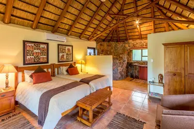 a bedroom with a large bed in a room at Iketla Lodge in Ohrigstad