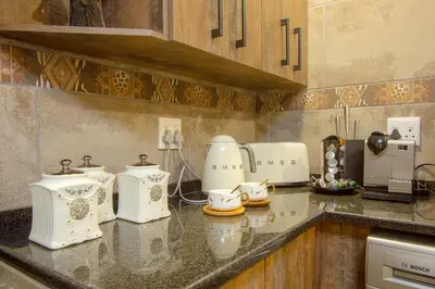 a kitchen with white appliances on a counter at Kaya KaBush in Marloth Park