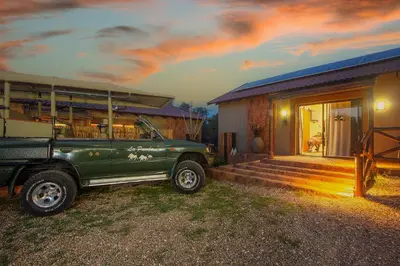 a green truck parked in front of a house at Kaya KaBush in Marloth Park