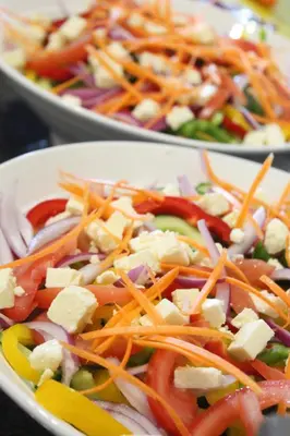 a plate of vegetables with cheese and other vegetables at Magnolia Hotel in Middelburg