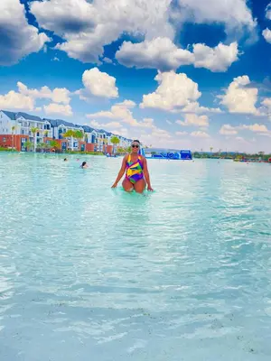 a woman in a bikini in the water on a beach at The blyde-Luxury one bedroom apartment in Pretoria