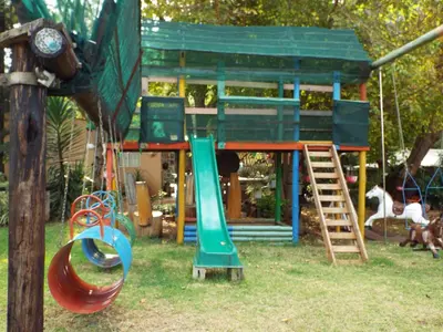 a playground with a slide and a play structure at Aloes Country Inn in Waterval Boven