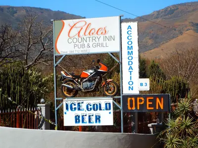 a sign for a cafe with a motorcycle on it at Aloes Country Inn in Waterval Boven