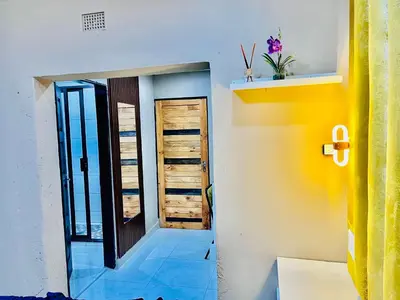 a hallway of a house with a yellow and white wall at Executive Galaxy Guest House Nkowankowa in Nkowakowa