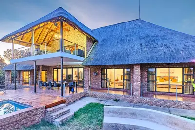 a large house with a pool in front of it at Shasha Lodge, Mabalingwe Game Reserve in Mabula