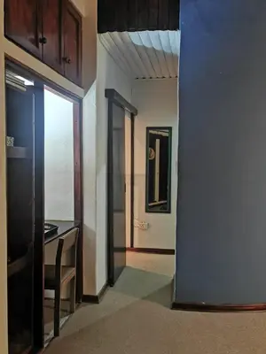 a hallway with a door open to a room with a table at The Homestay in Nelspruit
