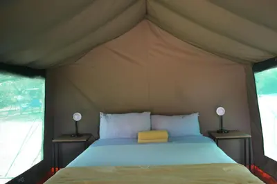 a bedroom with a bed in a tent at Kruger Yebo Safari Tents-Stay Inside Kruger in Skukuza