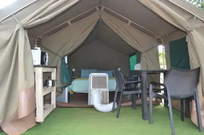 a tent with a table and chairs in it at Kruger Yebo Safari Tents-Stay Inside Kruger in Skukuza