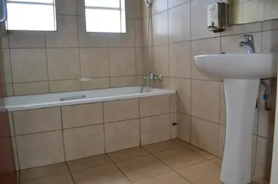 a bathroom with a sink and a bath tub at Kruger Yebo Safari Tents-Stay Inside Kruger in Skukuza