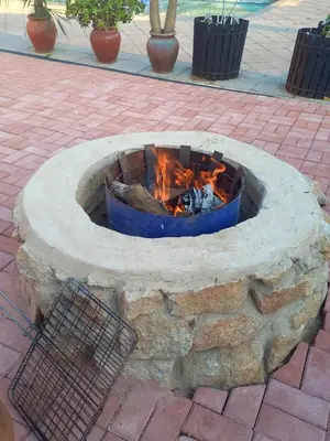 a fire pit on a brickickedicked sidewalk with a fire at Beit-El BnB in Polokwane