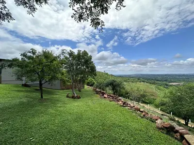 a view of a yard with rocks and trees at Hazyview Accommodation, Bon Repose Cottages 3&4 in Hazyview