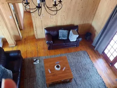 a living room with a leather couch and a coffee table at Habibi Holiday Home in Marloth Park
