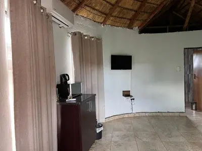 a room with a tv on the wall and a television on a wall at THE BRIDGE BOUTIQUE LODGE in Moletlane