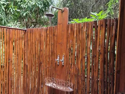 a wooden fence with a water fountain on it at Paradise River Lodge in Hoedspruit