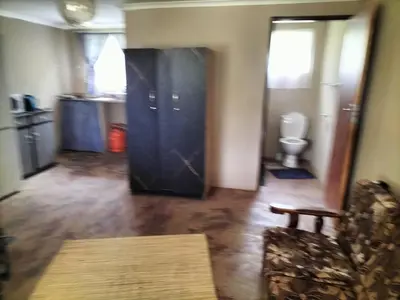 a living room with a couch and a toilet at BLESSINGS Sleep Over in Mokopane