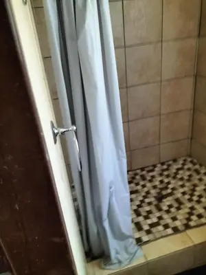 a shower with a white shower curtain in a bathroom at BLESSINGS Sleep Over in Mokopane
