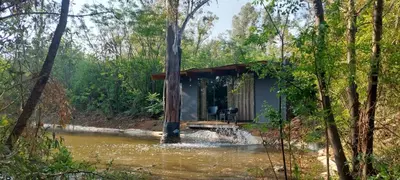 a house in the middle of a river in the woods at Vulture's View 9 in Hartbeespoort