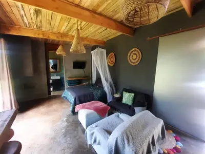 a living room with two beds and a couch at Vulture's View 9 in Hartbeespoort
