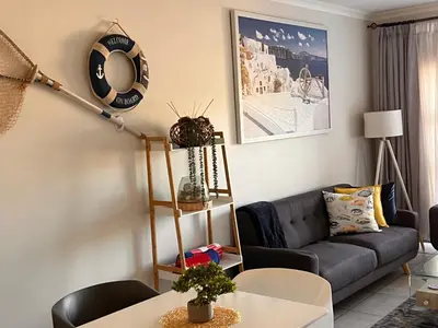 a living room with a couch and a table at The Blyde Crystal Lagoon Luxurious Apartment in Pretoria