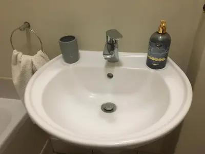 a white sink with a bottle on top of it at Panache Wildlife Cottage-Self Catering in Hoedspruit