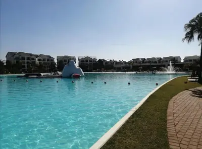 a large swimming pool with an inflatable at Three Bedroom Apartment At The Blyde in Boschkop