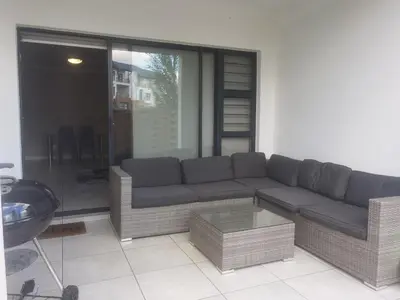 a living room with a couch and a table at Three Bedroom Apartment At The Blyde in Boschkop