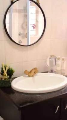 a bathroom with a sink and a mirror at Perfectly located beauty in secure Estate in Sandton