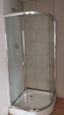 a shower with a glass door in a bathroom at Jay's Guest House in Witbank