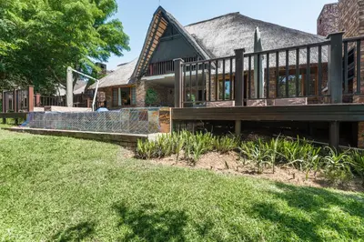 a house with a large deck and a porch at Kruger Park Lodge Unit No 521 with Private Pool in Hazyview