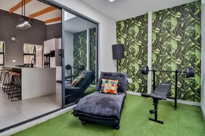 a living room with a chair and a desk at House of Bongekile 4 Bed Luxury Home in Malelane in Malelane