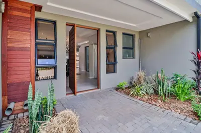 a front door of a home with a brick walkway at House of Bongekile 4 Bed Luxury Home in Malelane in Malelane