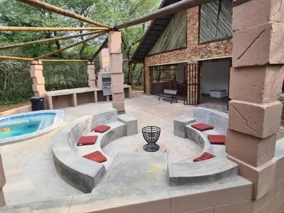 a patio with a swimming pool and a house at Dream Inn in Marloth Park