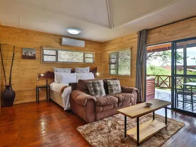 a living room with a couch and a bed at Marloth Kruger View in Marloth Park