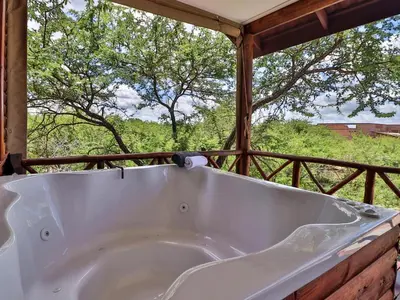 a bath tub sitting on top of a porch at Marloth Kruger View in Marloth Park