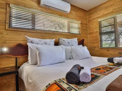 a bedroom with a bed with towels on it at Marloth Kruger View in Marloth Park
