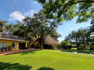 a house with a yard with a tree and a pool at Pecan Nut Place in Dalmada AH