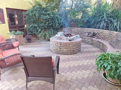 a patio with chairs and a fire pit in a yard at Pecan Nut Place in Dalmada AH