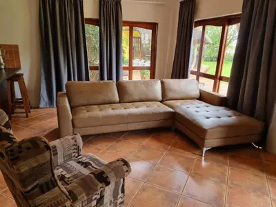 a living room with a couch and a table at Pecan Nut Place in Dalmada AH