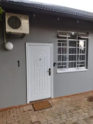 a house with a white door and a window at 21on2nd Avenue in Tzaneen