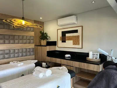 a dining room with two beds and a tv at Panorama Boutique Guest House in Graskop