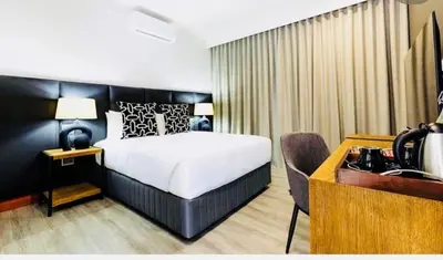 a hotel room with a bed and a desk and a desk at Panorama Boutique Guest House in Graskop