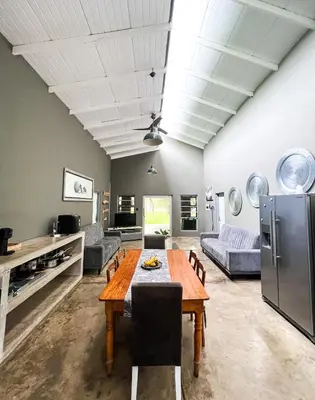 a large living room with a table and a refrigerator at Ukuthula @ the Kruger in Marloth Park