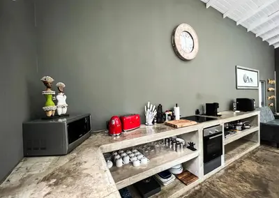a kitchen with a counter with a clock on the wall at Ukuthula @ the Kruger in Marloth Park