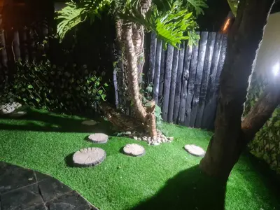 a garden with rocks and a fence at Country Cabin in Midrand