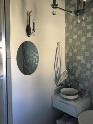 a bathroom with a toilet and a mirror at Oak Tree Lodge, Beaulieu, Kyalami in Midrand