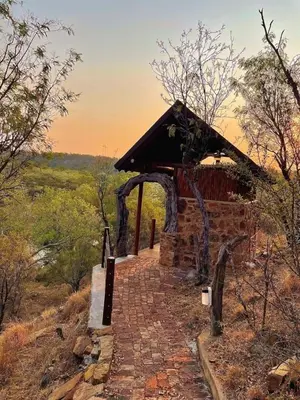 a stone path leading to a building on a hill at Oryx Wilderness Game Lodge and Tented Camp in Rhenosterfontein