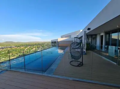 a view of a swimming pool from the balcony of a building at Menlyn Maine Gem in Pretoria